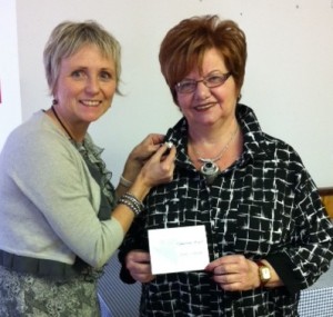 Nancy Warren awarding Barb Schoof a Guardian Angel Pin